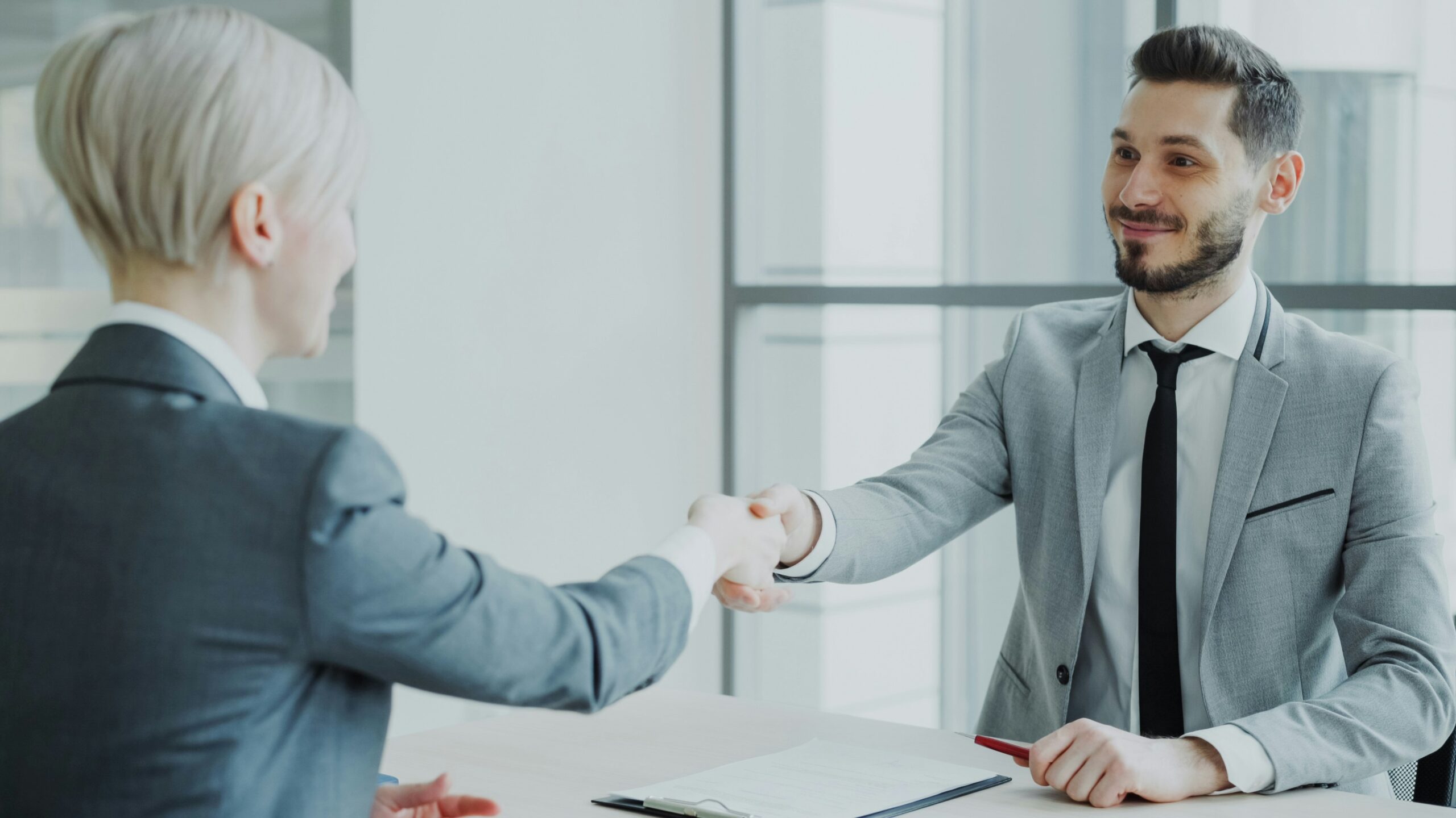 Professionals shaking hands in an office